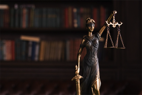 lady justice with the sword in her right hand along with a scale in her left, with her eyes blindfolded