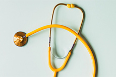 A stethoscope lies against a clean backdrop.