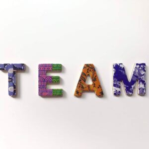 Colourful cutout capital letters spelling out the word 'TEAM'.